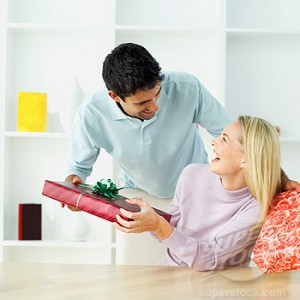 young man giving a present to a young woman